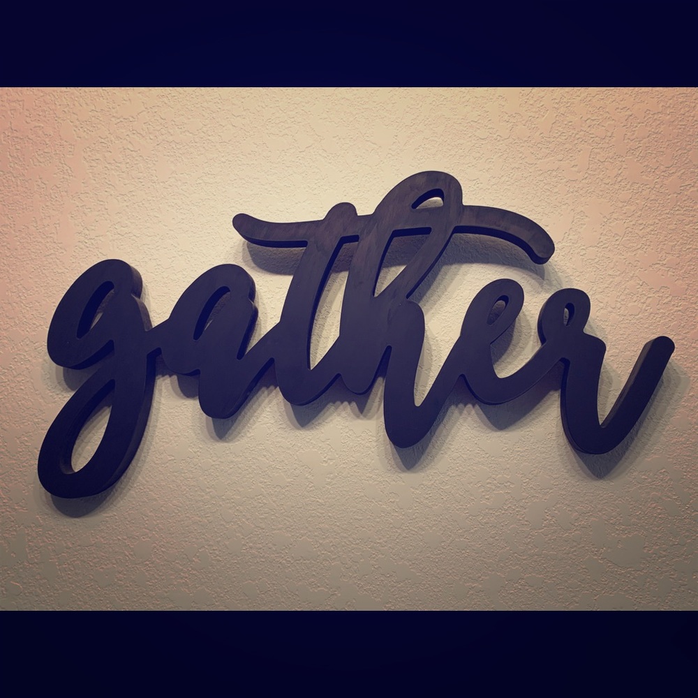 Black “Gather” wall sign